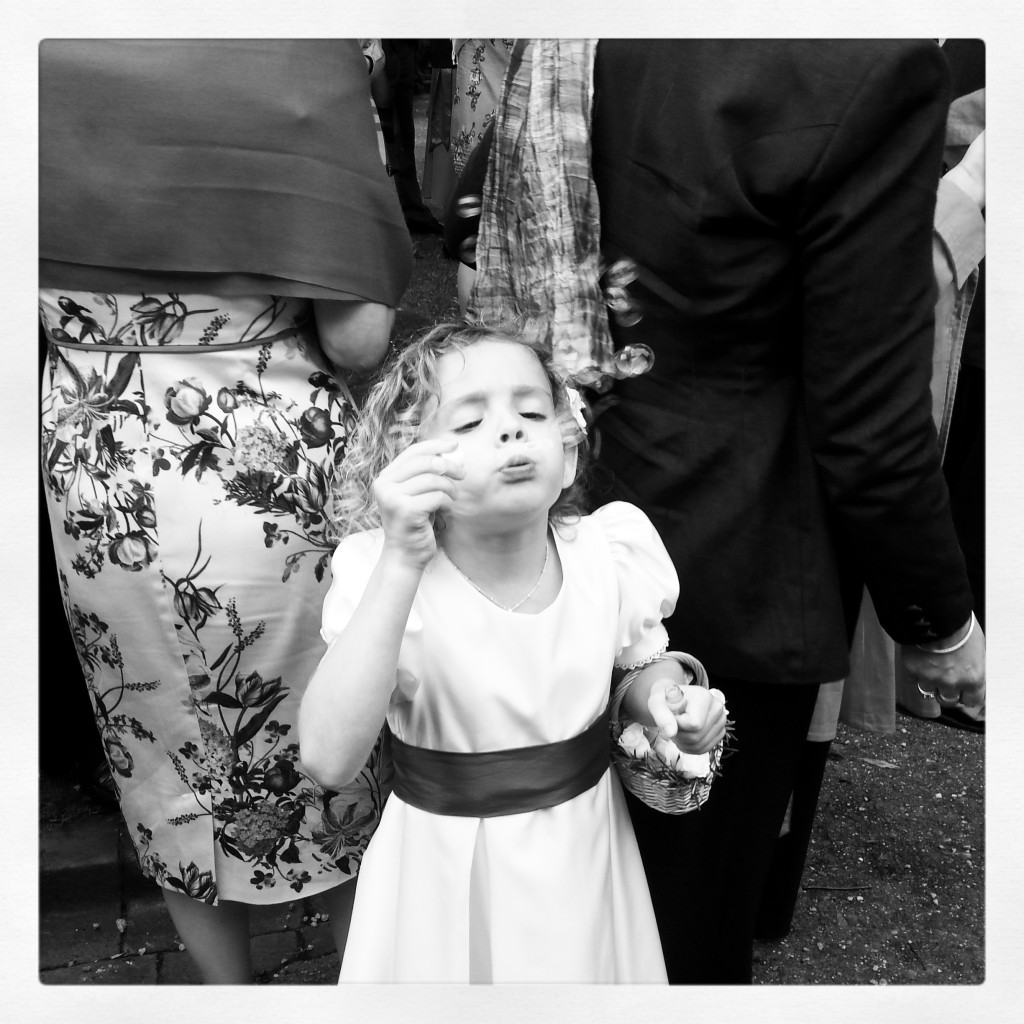 L blowing bubbles outside the church
