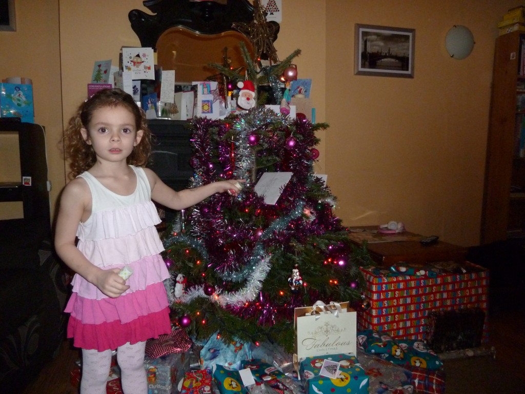 L with our tree on Christmas morning last year
