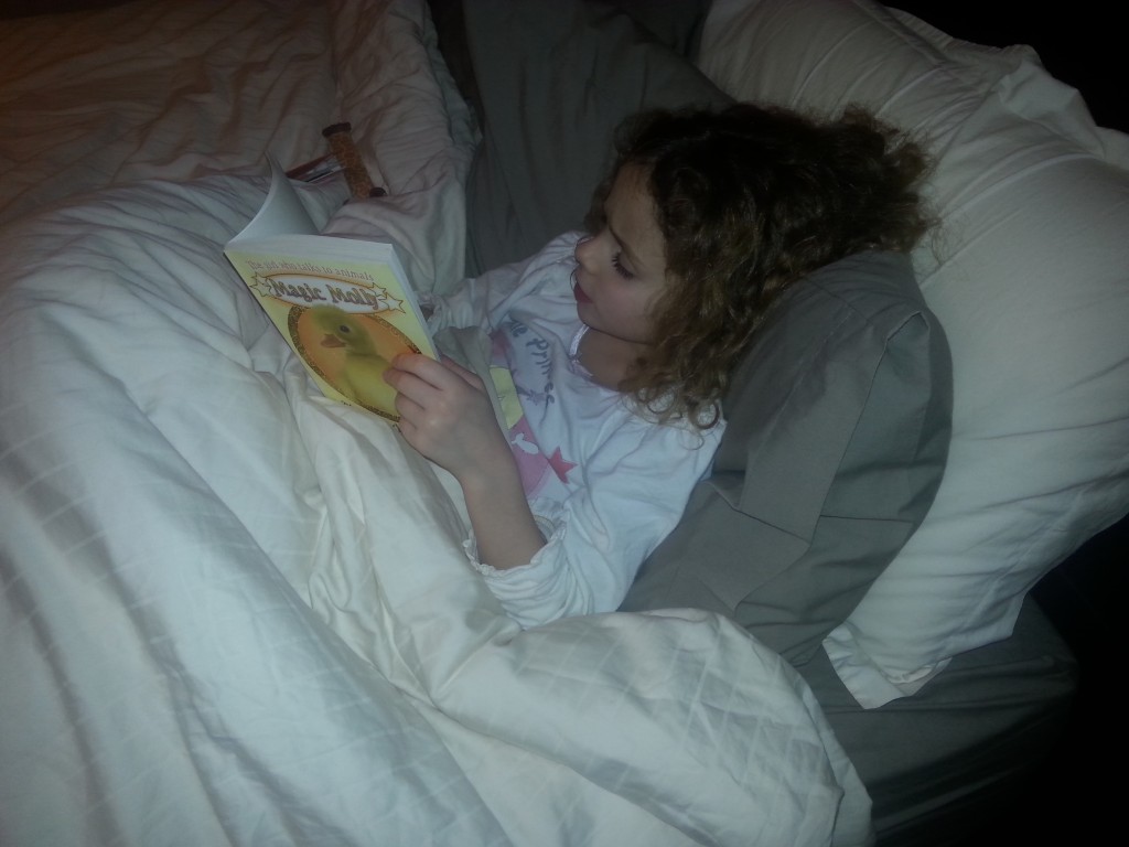 L reading to herself before bed last night - her love of books has been fuelled by school.