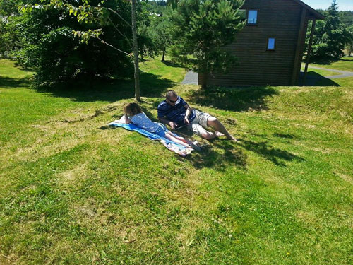Father and daughter relaxing in the sun on holiday www.FranglaiseMummy.com