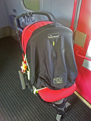 Pushchair on the train, with snooze shade